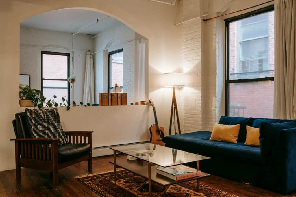 A living room of a spacious flat with several windows