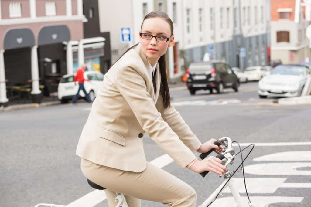A female employee riding her bike to the office